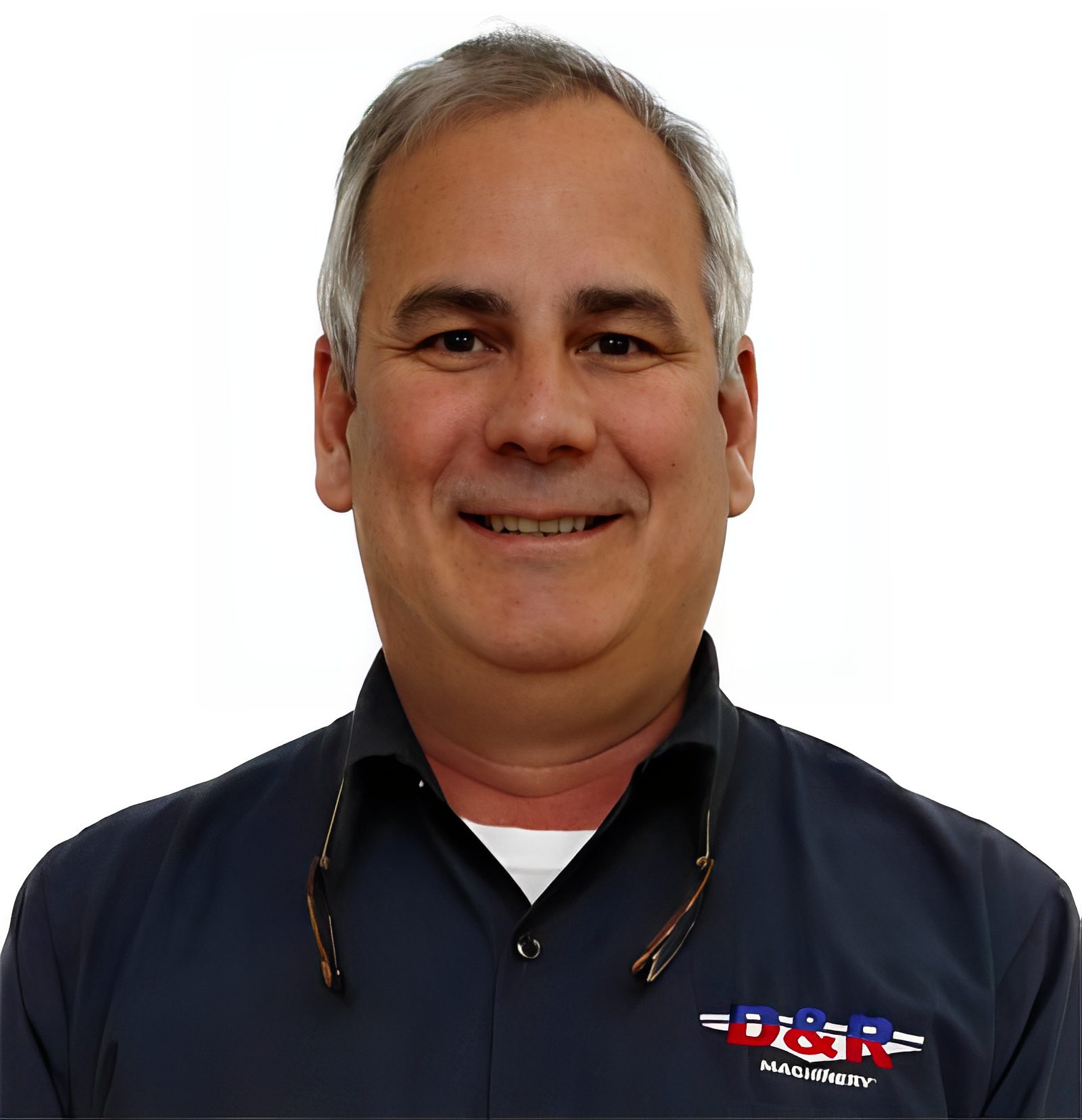 Man in dark shirt with logo smiling.